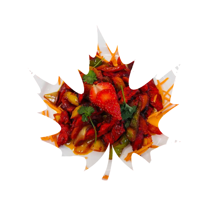 A colourful stir-fry with red peppers and strawberries on a maple leaf plate, framed by a leaf wreath.